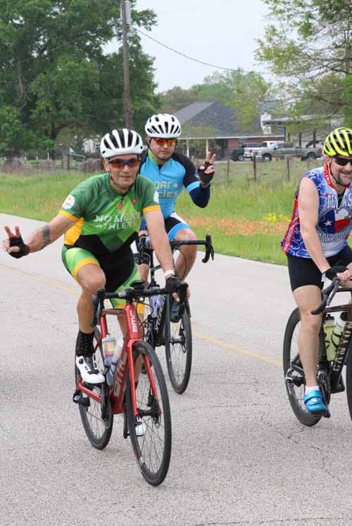 Cyclists riding in a charity event, promoting health and community with Bluebonnet Express.