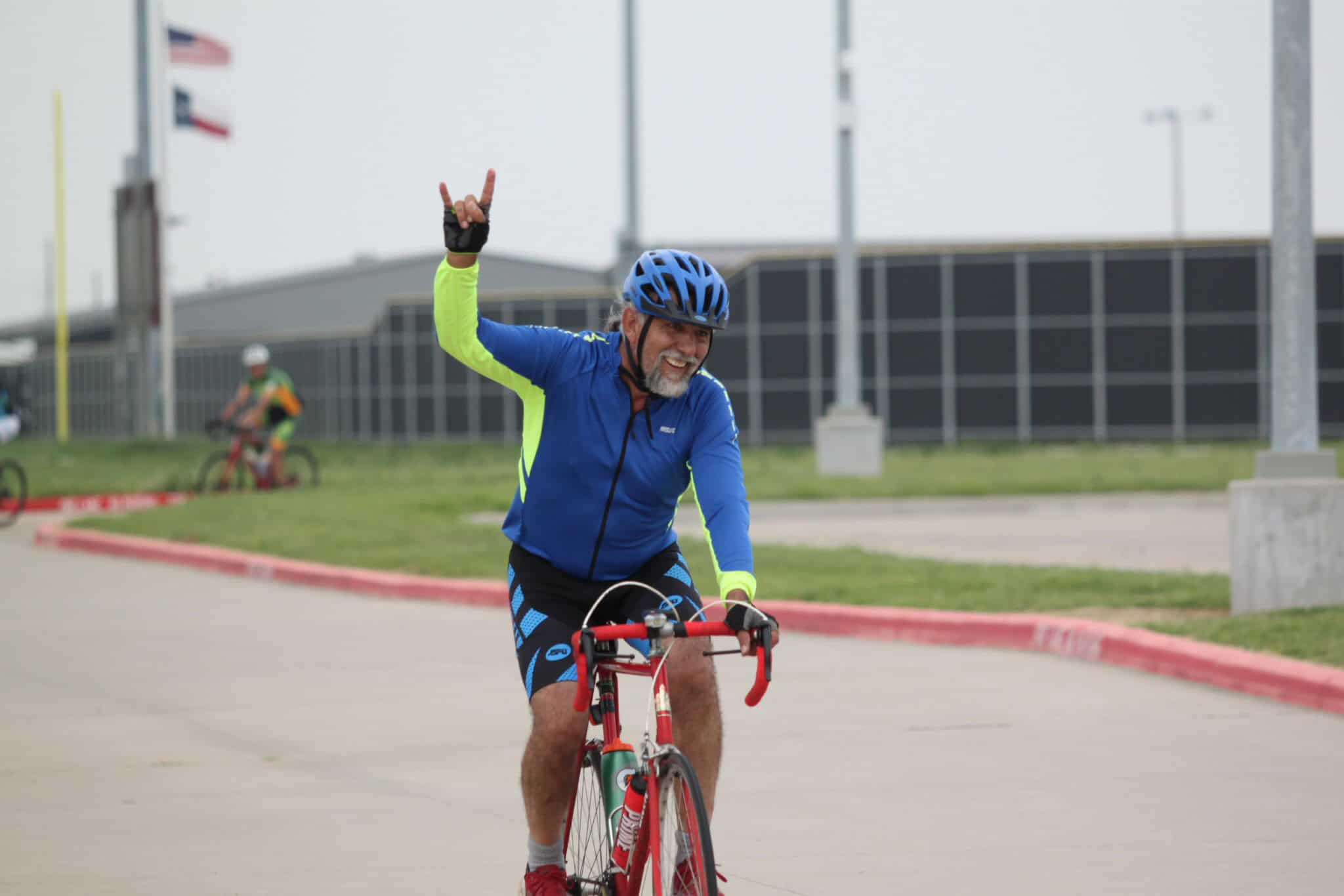 Vibrant bicyclist enjoying outdoor ride, showcasing Bluebonnet Express cycling experience.