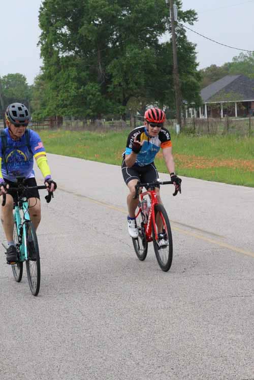 Kids riding bicycles on a rural road during a scenic bike ride event.