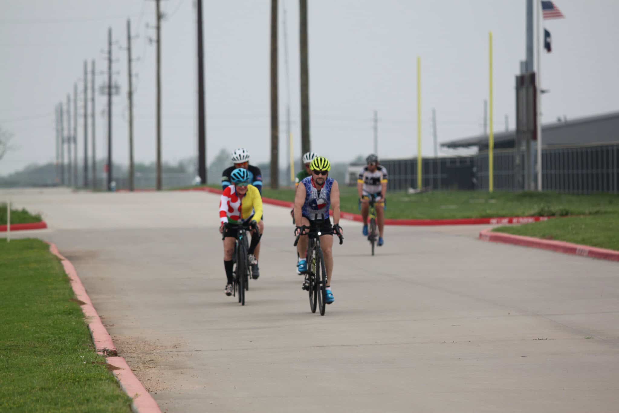 Cyclists riding on a paved road during Bluebonnet Express event in Texas.