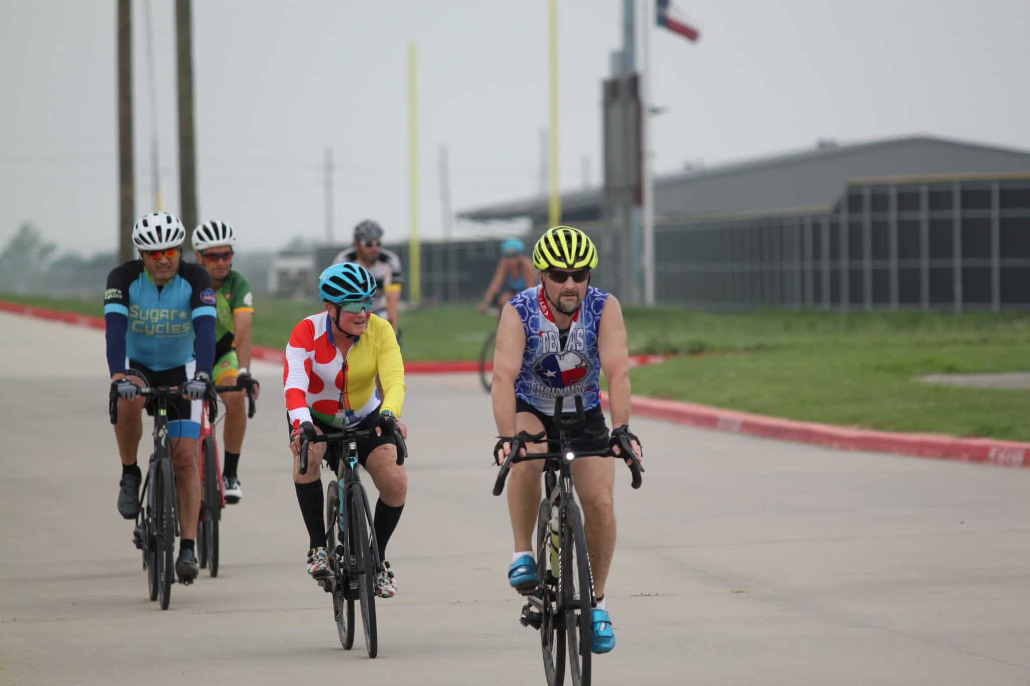 Bright cyclists riding on a trail during Bluebonnet Express event, promoting cycling sports.