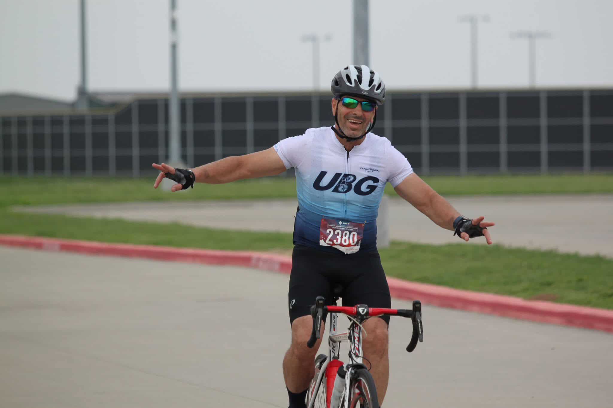 Vibrant cyclist enjoying outdoor ride with Bluebonnet Express biking gear and helmet.