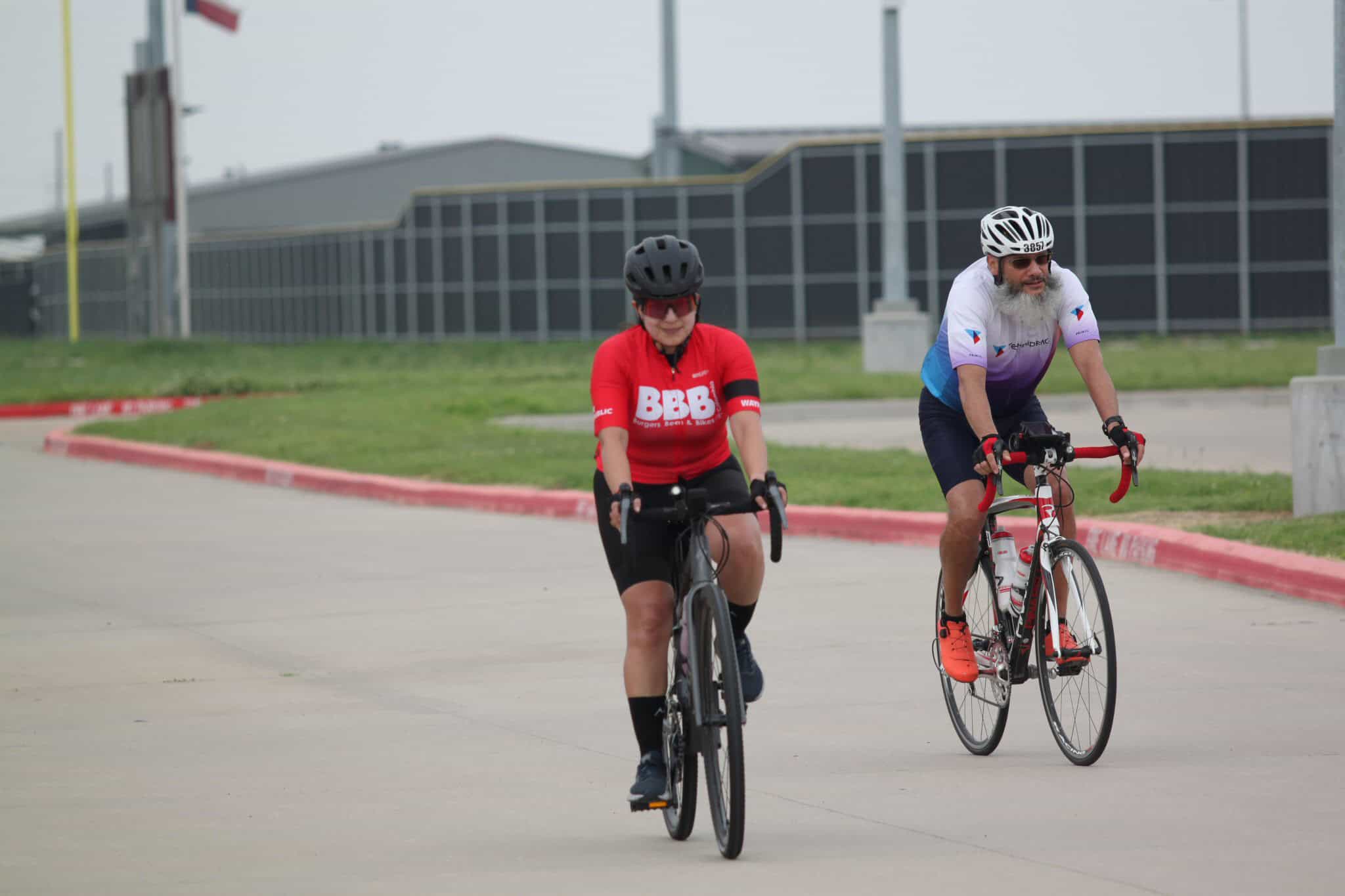 Cyclists riding on a road during Bluebonnet Express event for cycling enthusiasts in Texas.