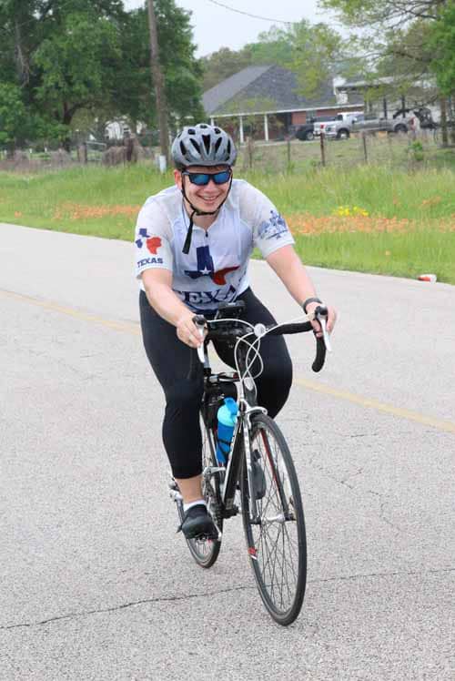 Cyclist riding on open road during Bluebonnet Express event, showcasing outdoor cycling and Texas-themed sports.