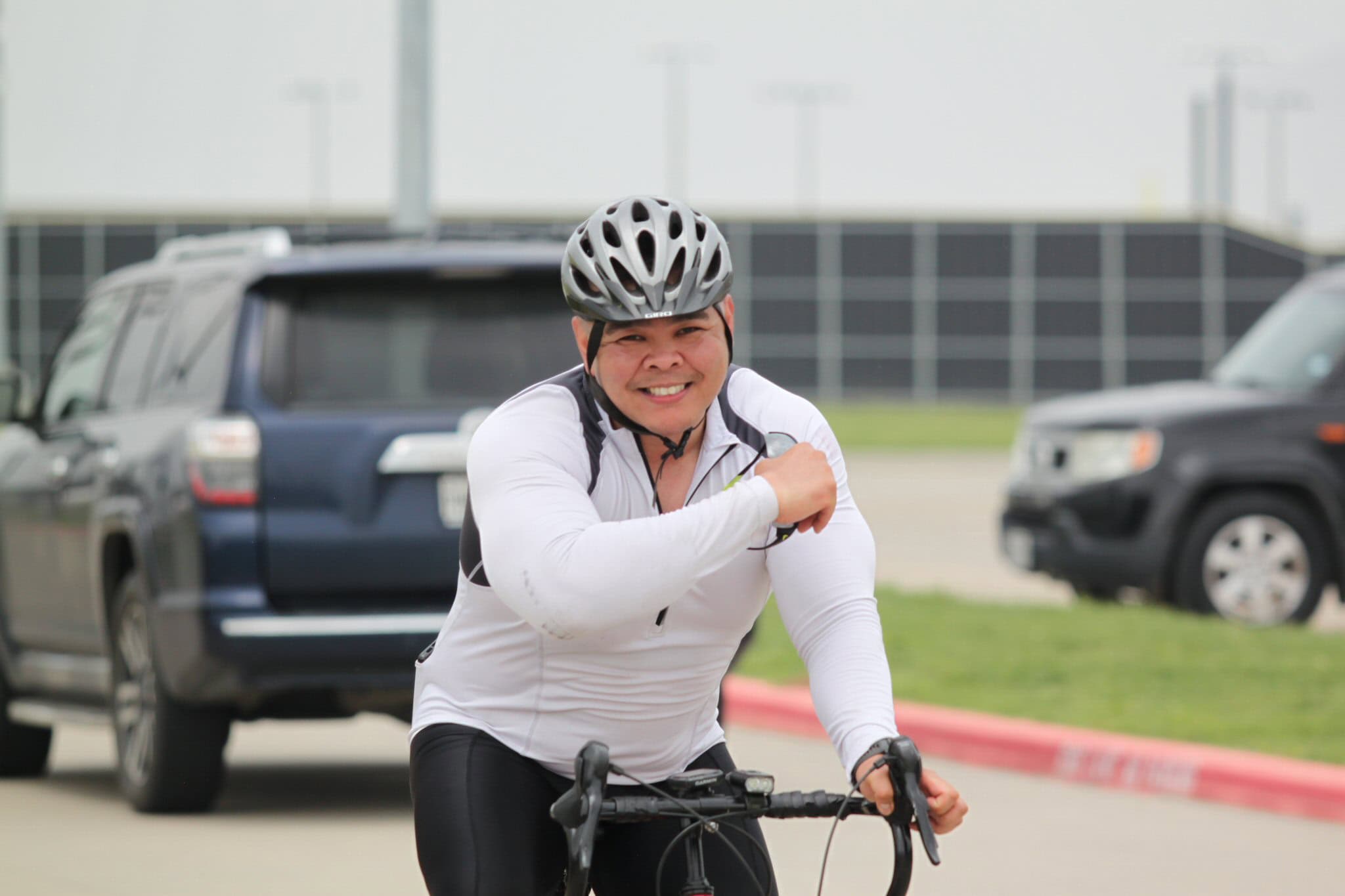 Bright smiling cyclist enjoying a ride with Bluebonnet Express, emphasizing comfort and scenic biking experiences.