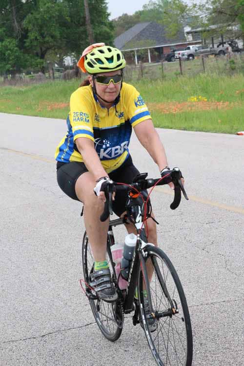 Cyclist riding on the road during Bluebonnet Express event, emphasizing outdoor cycling and charity rides.