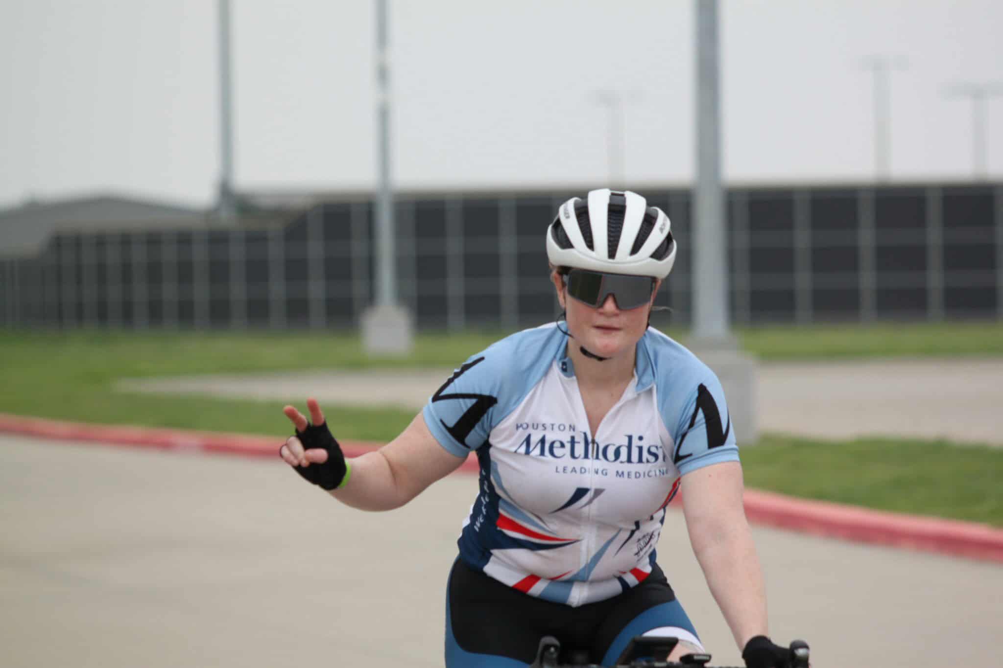Bike rider in speed cycling helmet and sunglasses, training on the road.