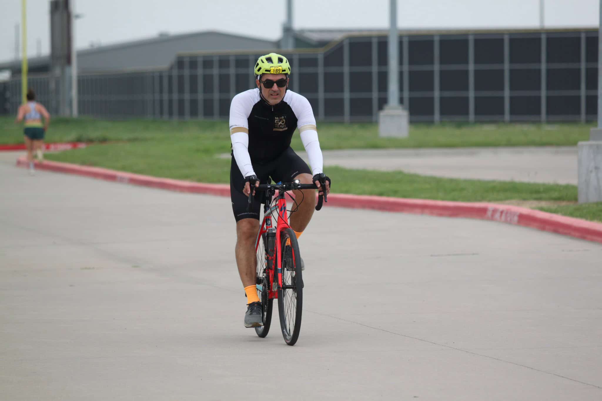 Bright yellow helmet and cycling gear on a male cyclist riding in the Bluebonnet Express event.