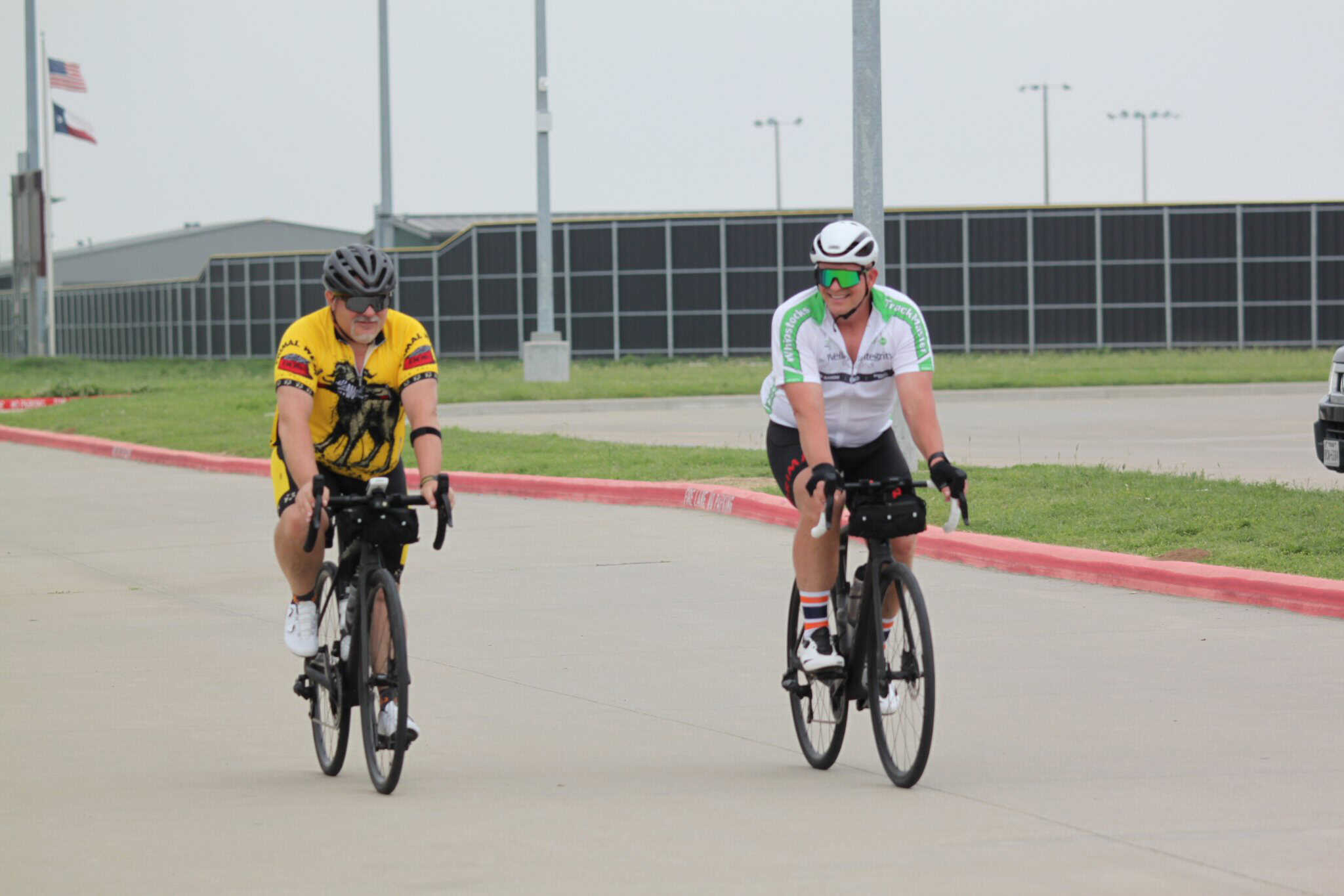 Stylish cyclists riding together on a road during daytime.