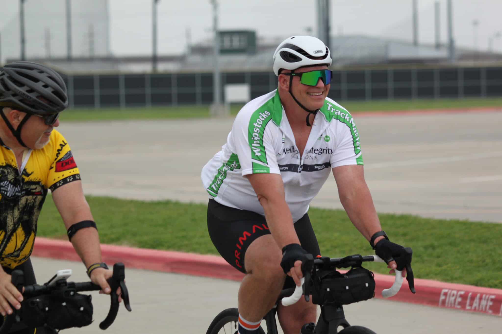 Riders on Brooklyn Bluebonnet Express cycling team at train station, promoting cycling events and community engagement.