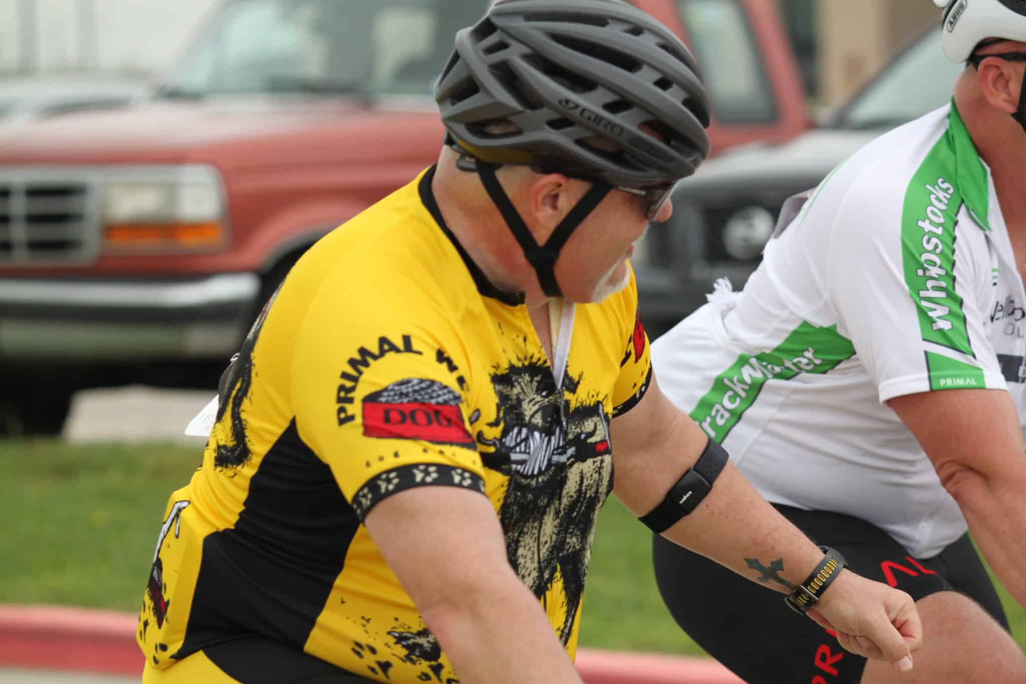 Bike riders in colorful jerseys, participating in Bluebonnet Express cycling event, outdoor sporting activity.