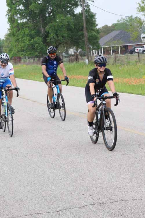 Kids riding bikes on a rural road during daytime, promoting outdoor recreation and cycling events.
