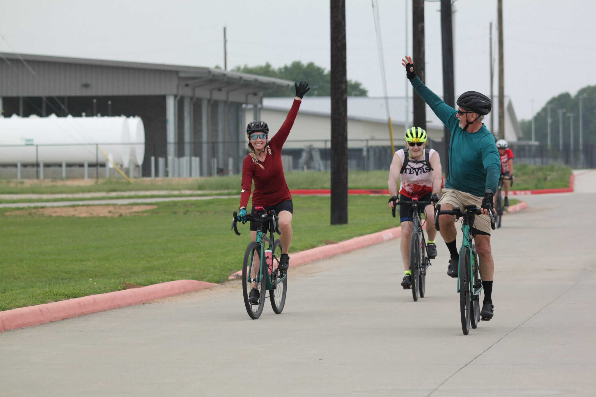 Smiling cyclists celebrating during the Bluebonnet Express bike ride event.