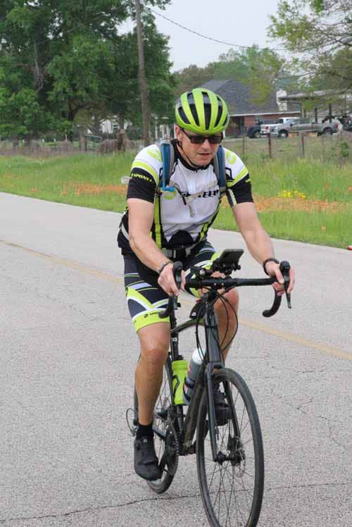 High-performance cyclist riding a bike on the road in Texas during daytime.