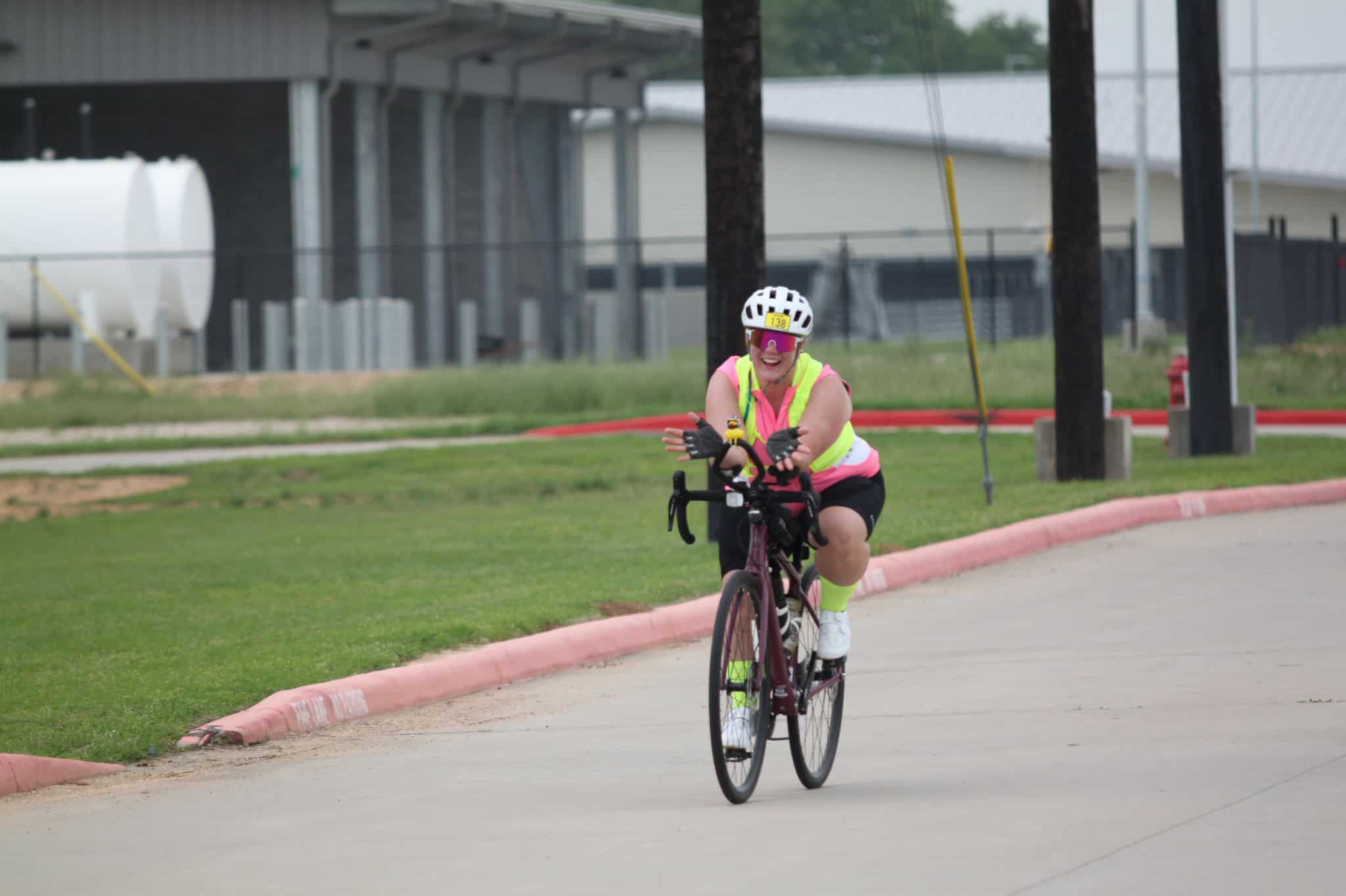 Bright cyclist enjoying Bluebonnet Express bike ride on scenic trail in Texas.