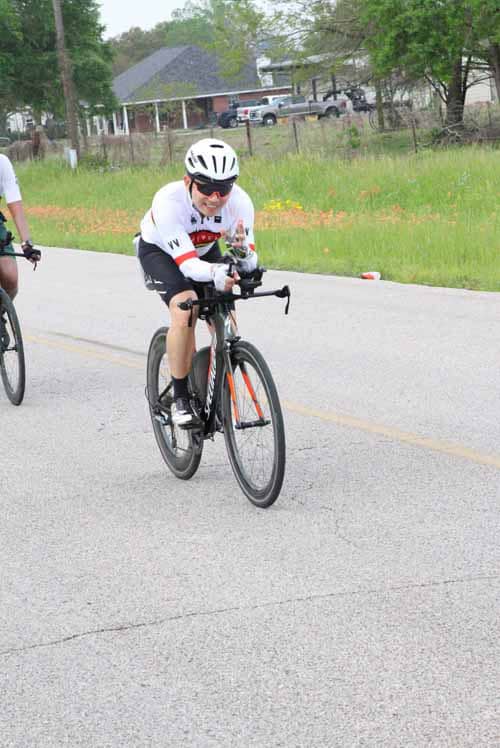 Bright cyclist riding on the road, enjoying outdoor biking experience.