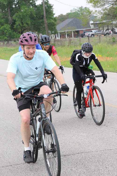 Riders enjoying a scenic bike ride with Bluebonnet Express in Texas, promoting outdoor activity and cycling fitness.