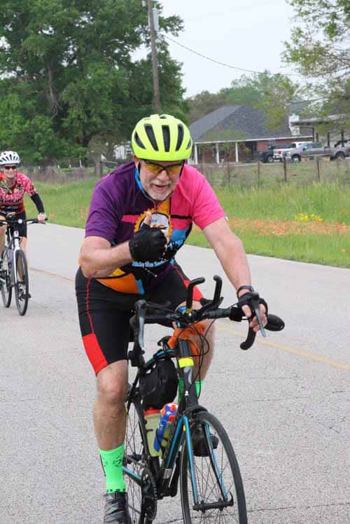 Bright yellow helmet and colorful cycling jersey during Bluebonnet Express bike race.