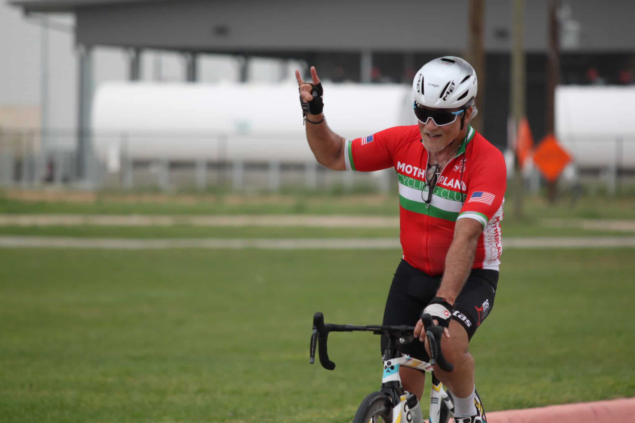 Vibrant cyclist celebrating after ride at Bluebonnet Express event, showcasing outdoor biking passion and triumph.