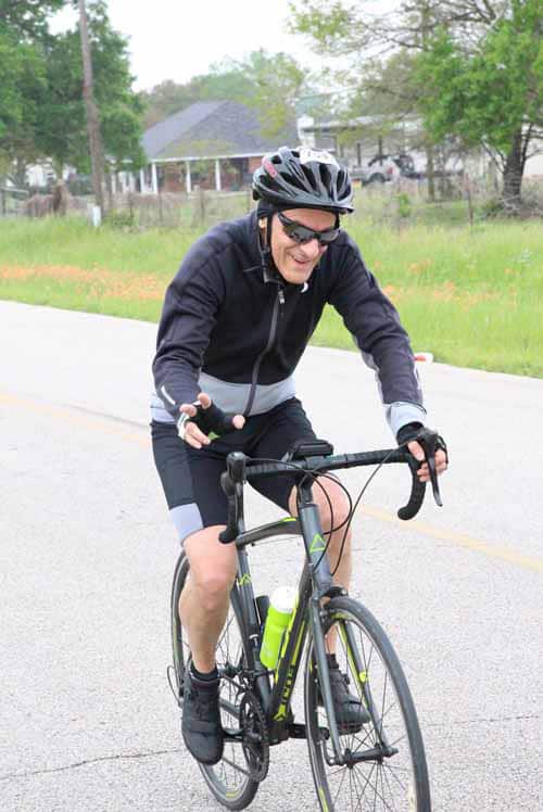 1. Active cyclist riding a road bike during a spring ride in Texas.