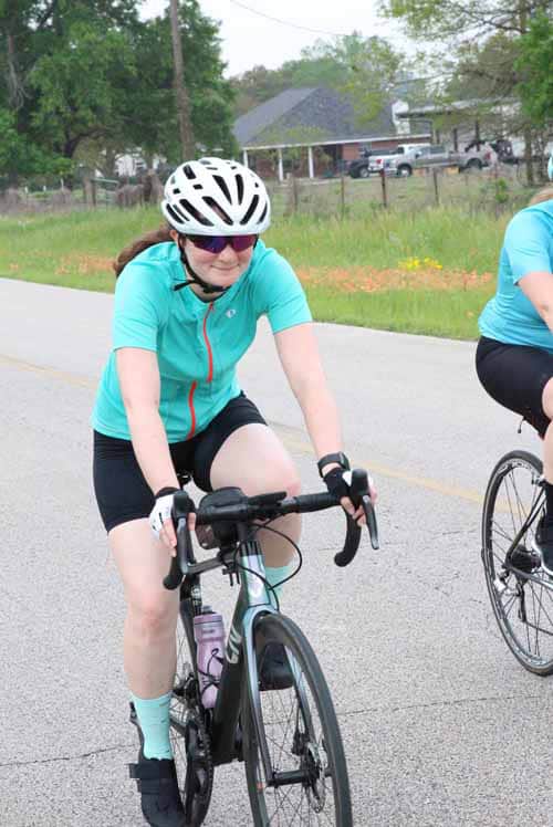 Friendly woman riding a bike during Bluebonnet Express event in Texas.