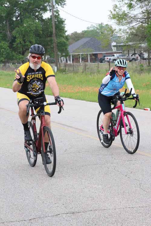 Brightly dressed cyclists enjoying a ride during Bluebonnet Express event in Texas, promoting community health and biking activities.