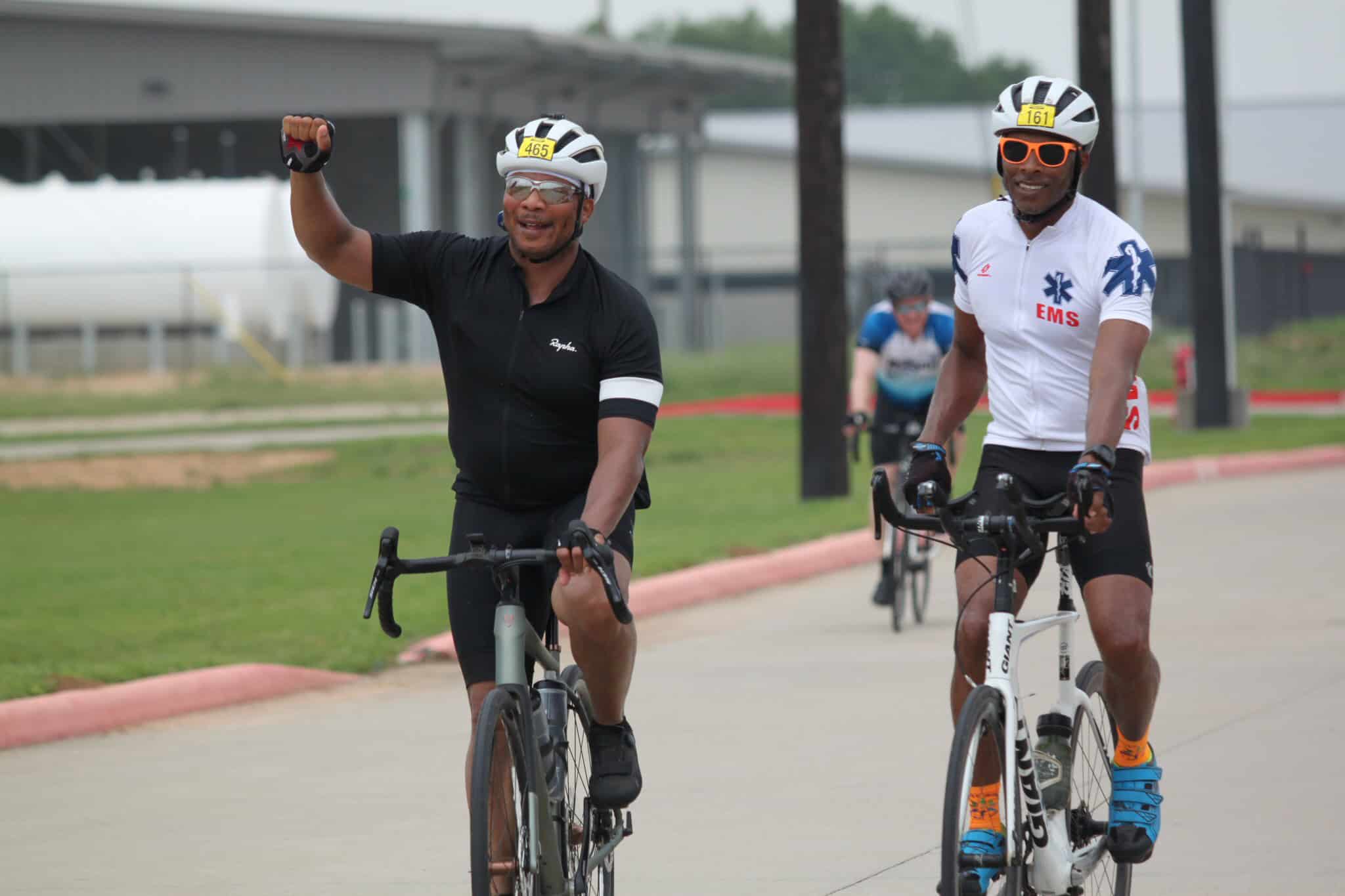 Bicycle riders celebrating during Bluebonnet Express cycling event in Texas.