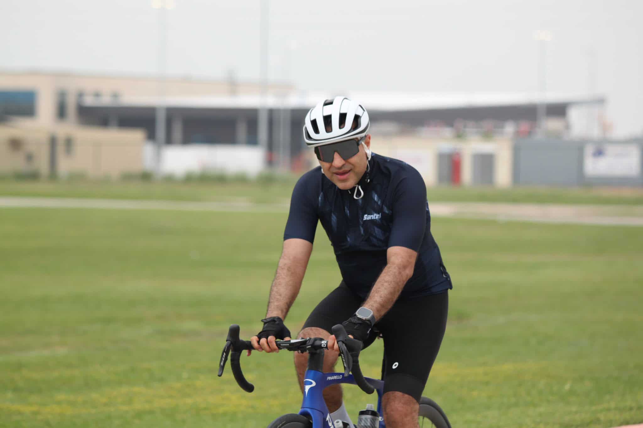 Energetic cyclist riding a bike outdoors during daytime at Bluebonnet Express event.