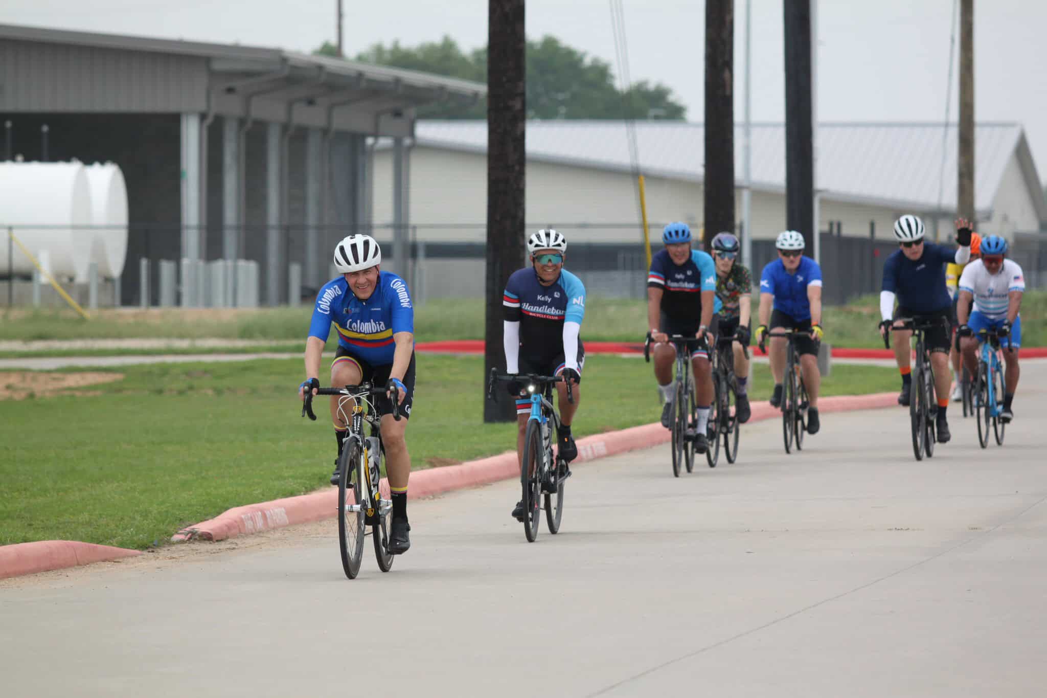 Cyclists riding on a paved road during the Bluebonnet Express event in Texas.