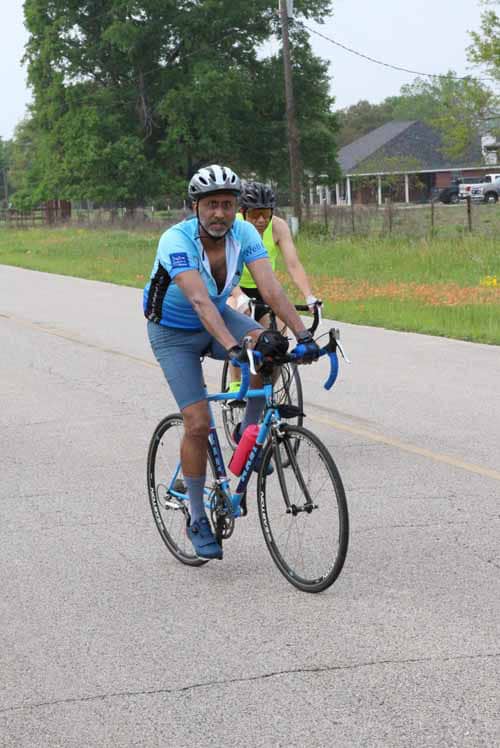 Comfortable cyclist riding on scenic road in Bluebonnet Express event.