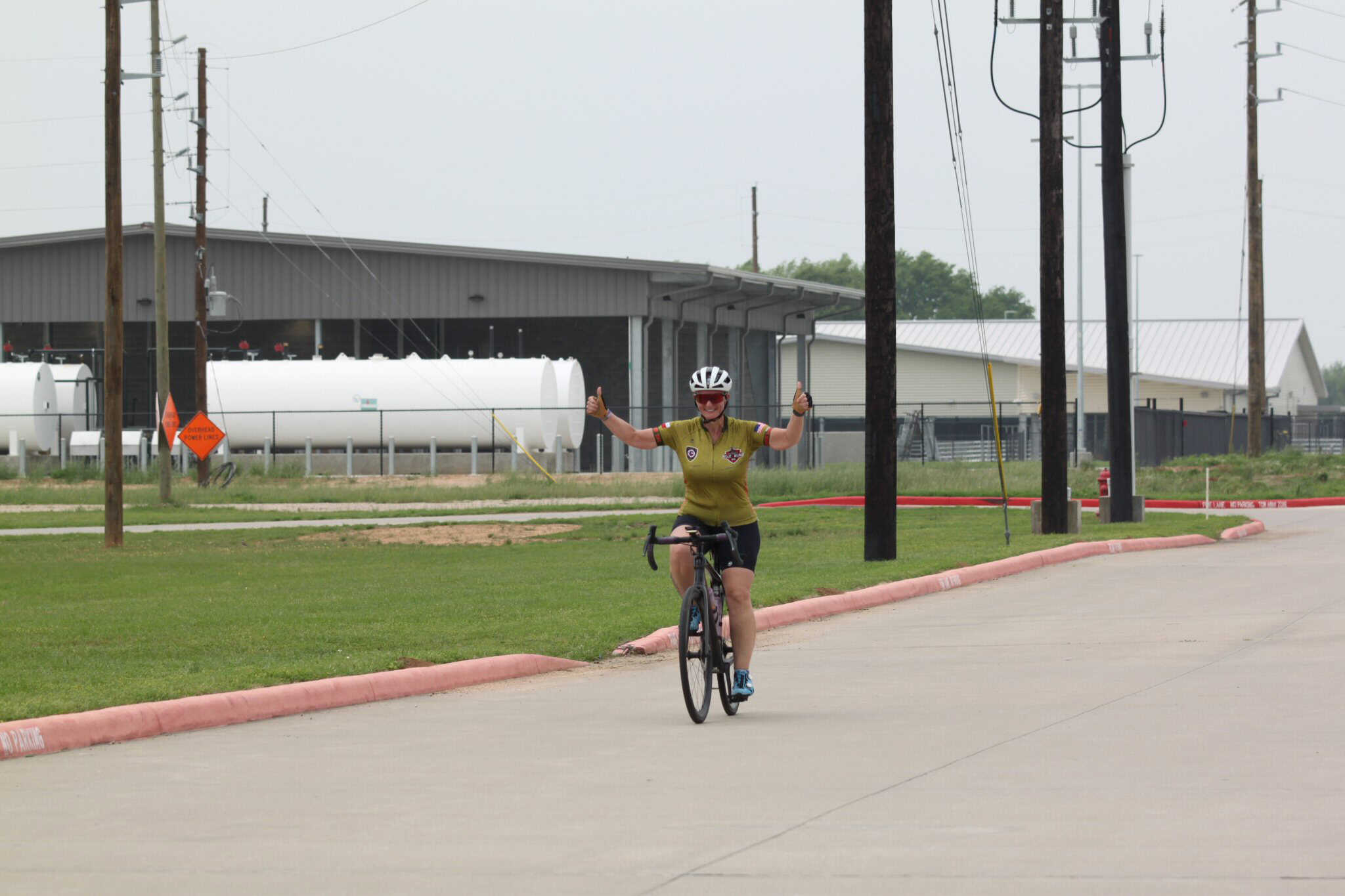Rider celebrating victory on Bluebonnet Express bike trail in Texas.