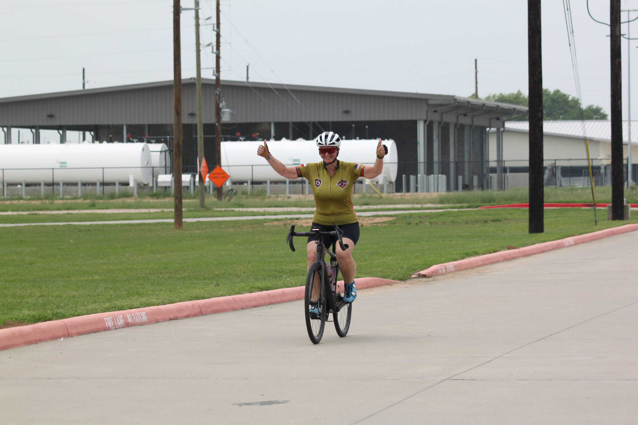 Bike rider celebrating on a road, promoting Bluebonnet Express bike service and cycling events.