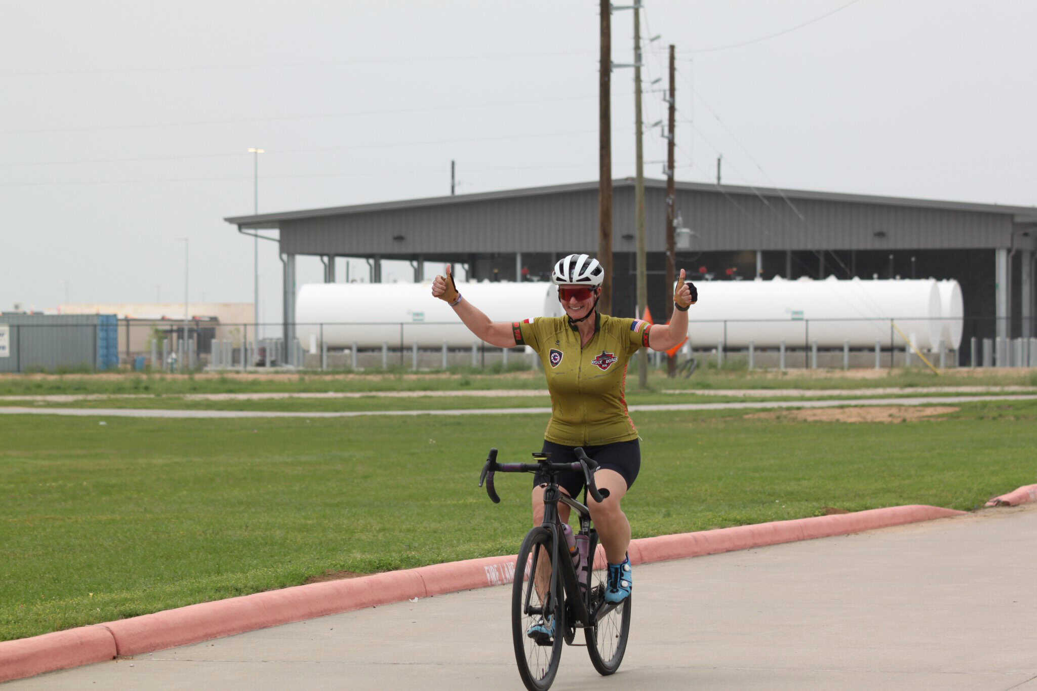 Sunny cyclist celebrating on the Bluebonnet Express bike trail in Texas.