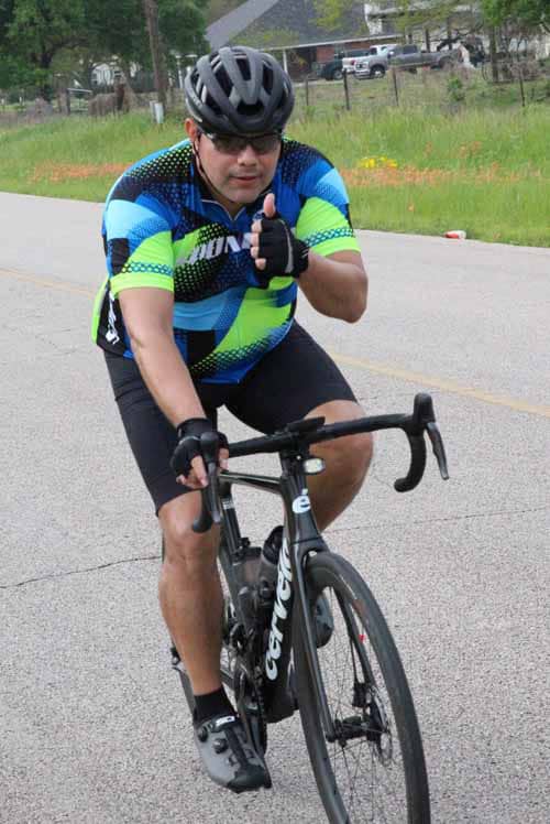 Bright cyclist on Bluebonnet Express bike route, offering a scenic outdoor biking experience.