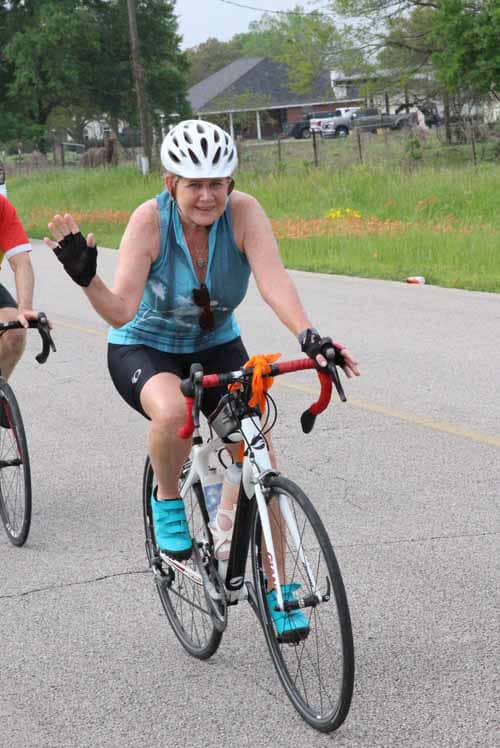 Smooth road biking at Bluebonnet Express, featuring a smiling woman enjoying her cycling ride.