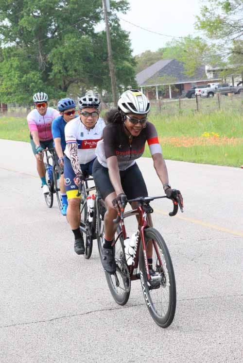 Vibrant cyclists riding during Bluebonnet Express event on scenic rural roads for outdoor fitness.