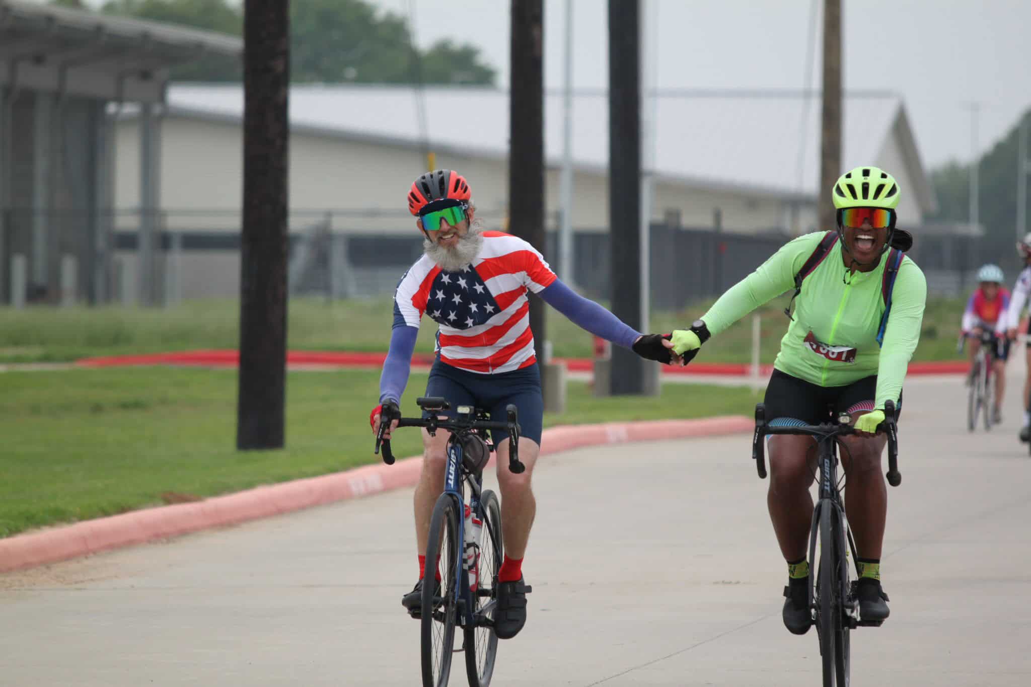 Brightly dressed cyclists enjoying a scenic ride on a clear day.