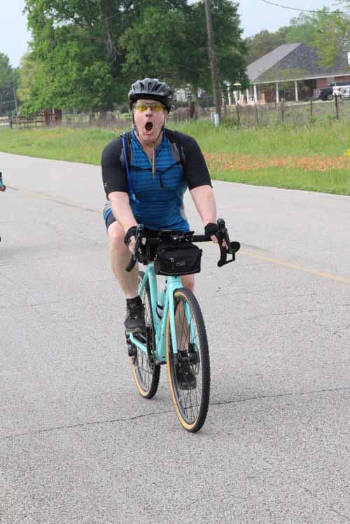 Bright cyclist expressing excitement on Bluebonnet Express bike trail.