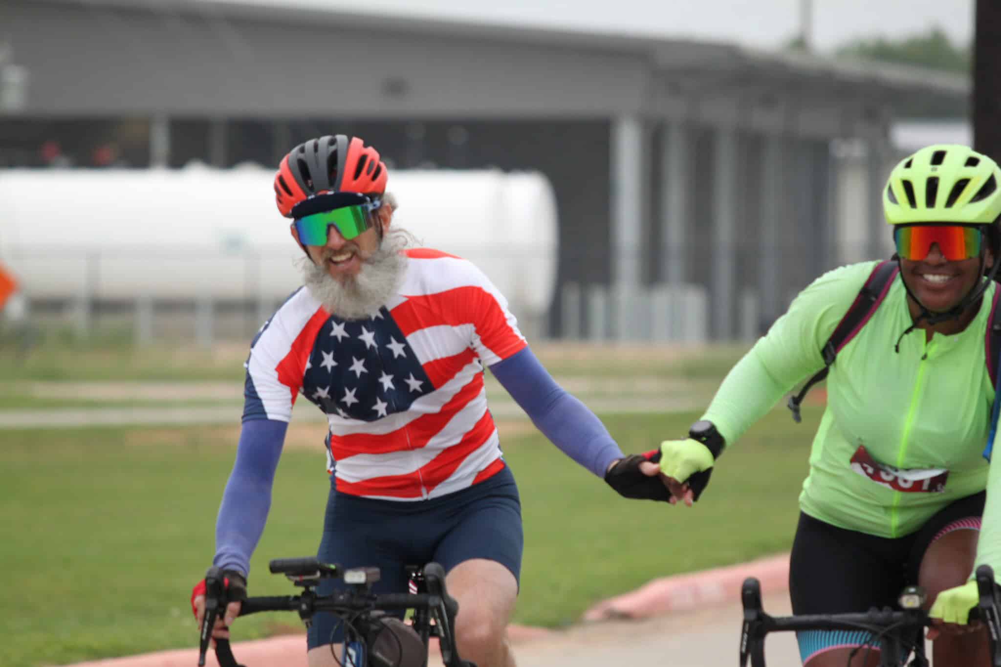 Colorful cyclists riding bikes, representing Greenway biking event, Texas, outdoors, healthy lifestyle.