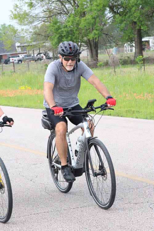 Active senior cyclist riding a mountain bike outdoors during daytime.