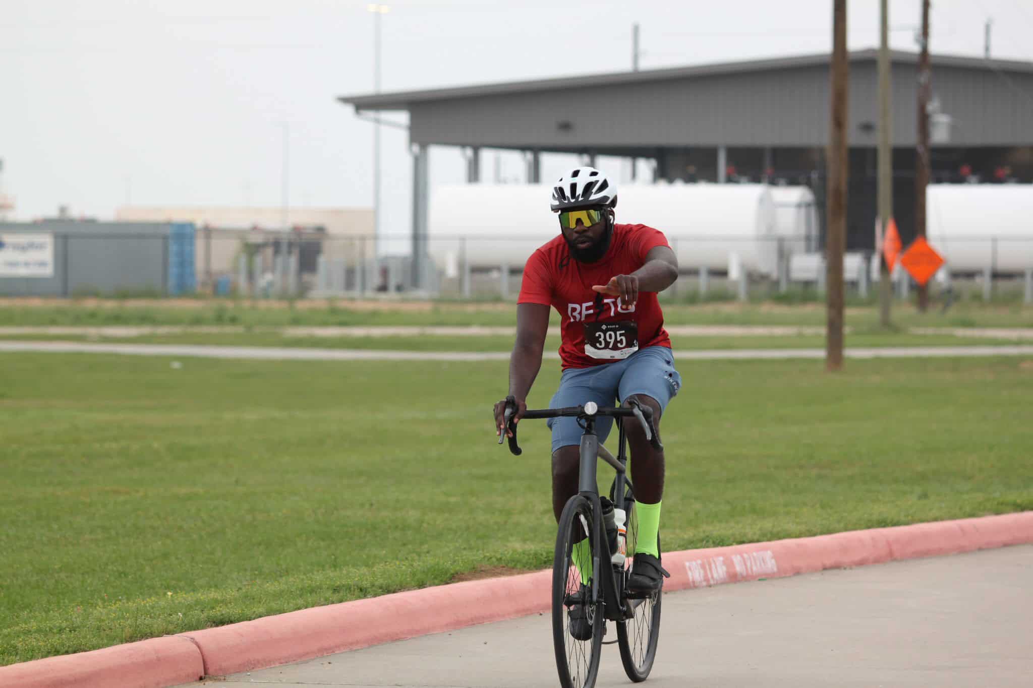 Bike rider wearing helmet and sunglasses during cycling event at Bluebonnet Express event.