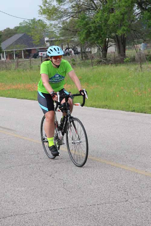 Bluebonnet Express cyclist riding on rural road in Texas.