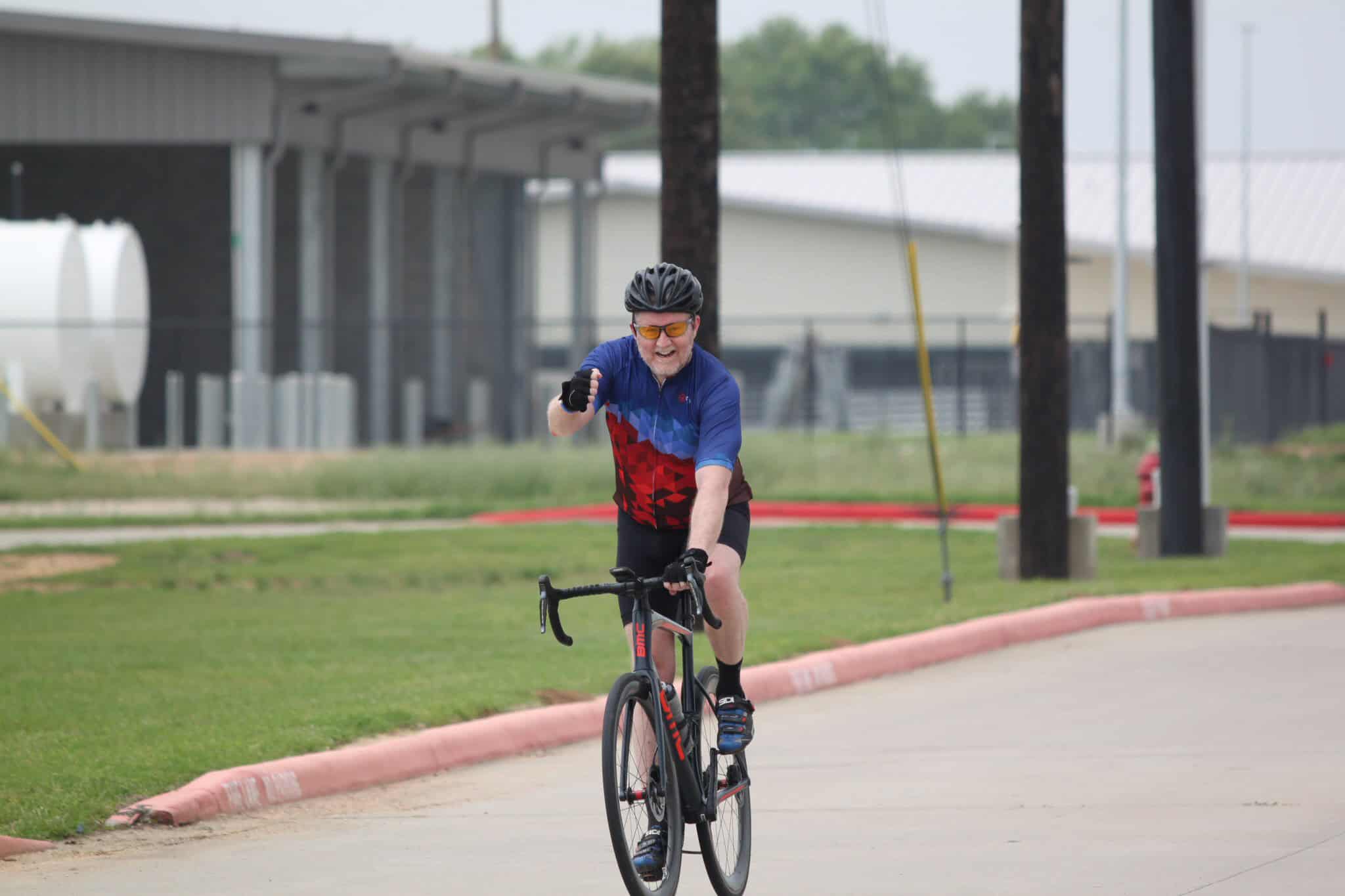 Vibrant cyclist on Bluebonnet Express bike trail, enjoying outdoor adventure and state-of-the-art cycling experience.