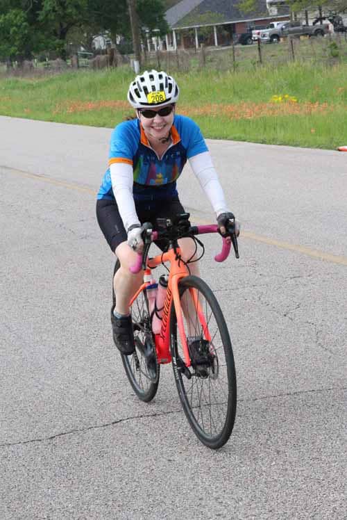 Vibrant cyclist riding a bike during Bluebonnet Express event in Texas.