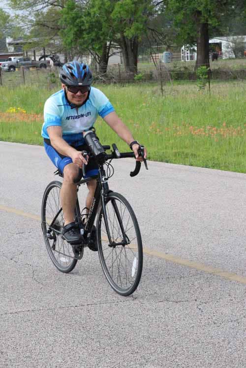 Rider on a bicycle during Bluebonnet Express event, enjoying outdoor cycling in scenic surroundings.