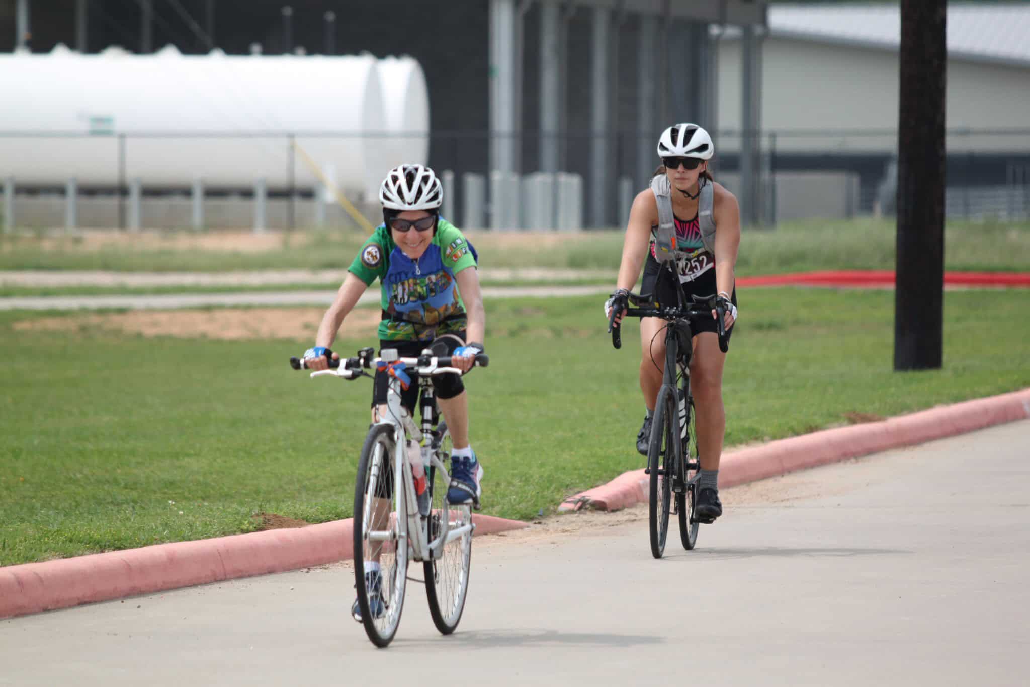 Energetic kids biking in the park with helmets and safety gear, enjoying outdoor cycling on a sunny day.