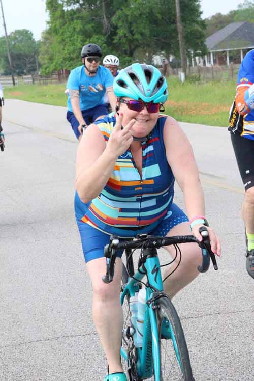 Colorful cyclist wearing helmet and sunglasses on Bluebonnet Express ride.