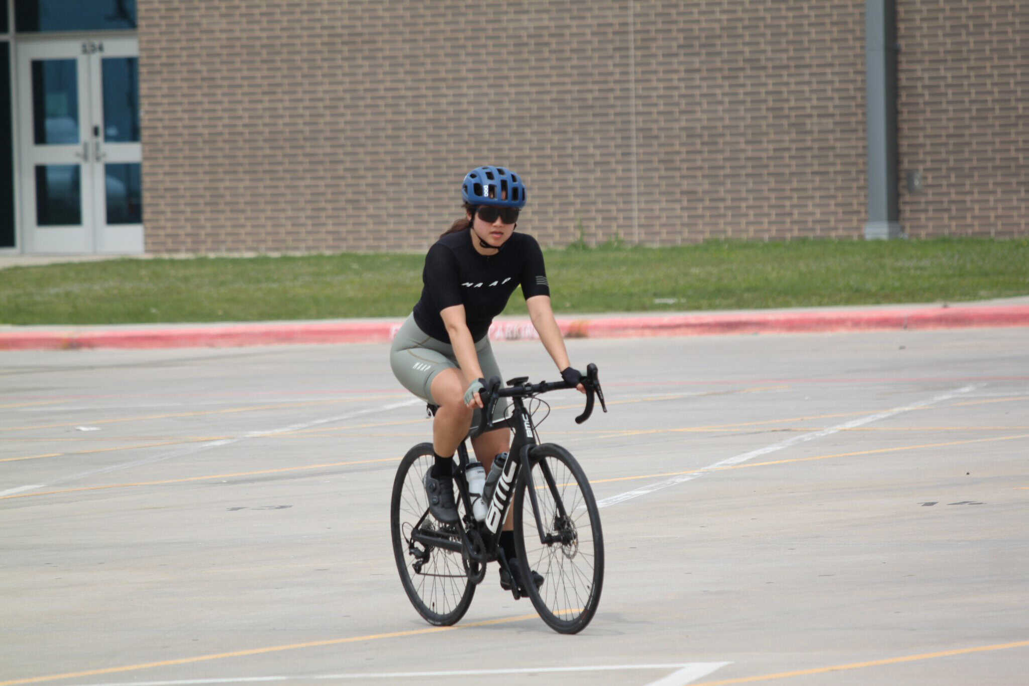 Bike rider on Bluebonnet Express cycling route in Texas, wearing helmet and sunglasses.