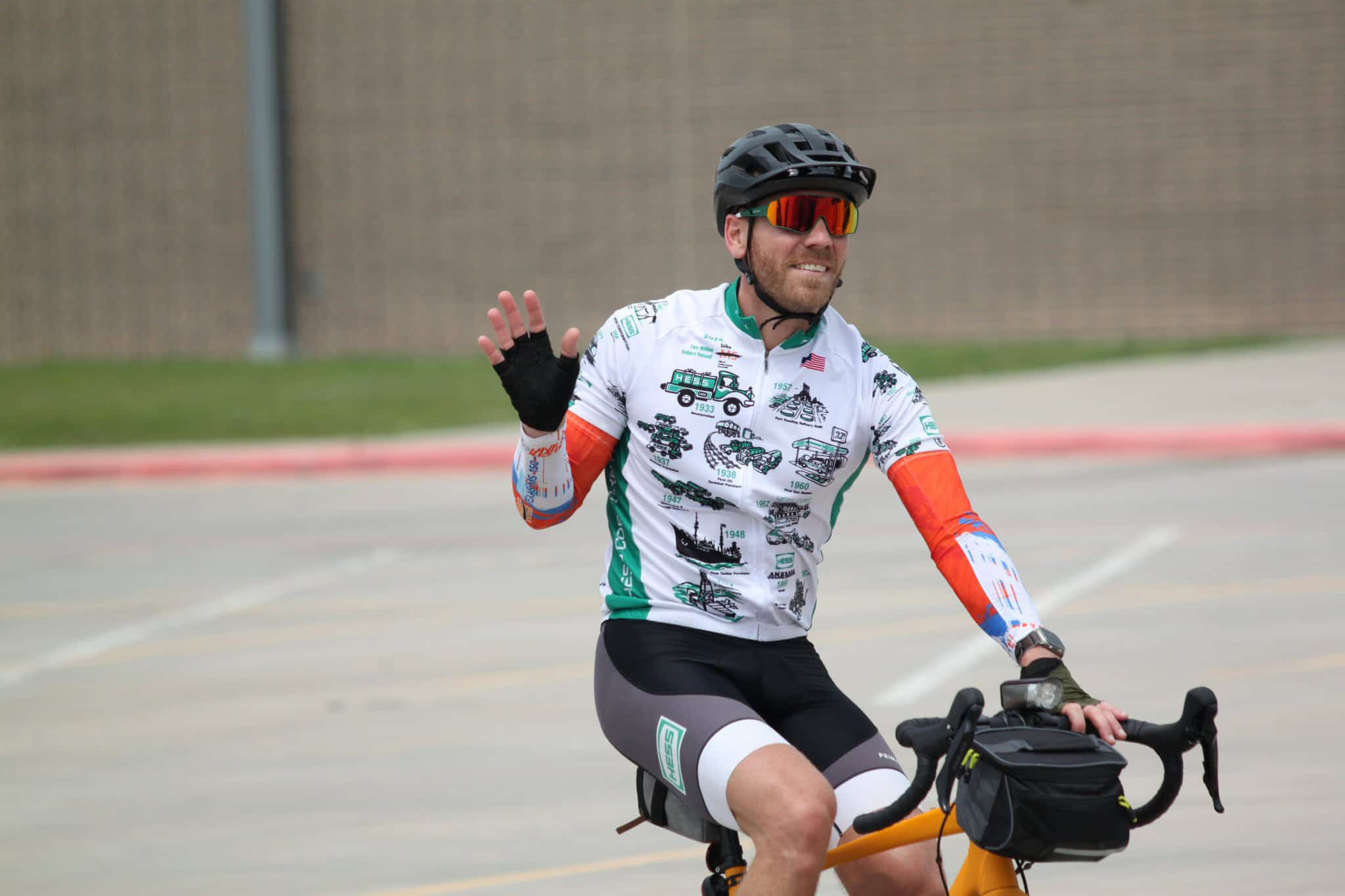 Cyclist riding a bike with helmet and sunglasses on a sunny day for Bluebonnet Express event.