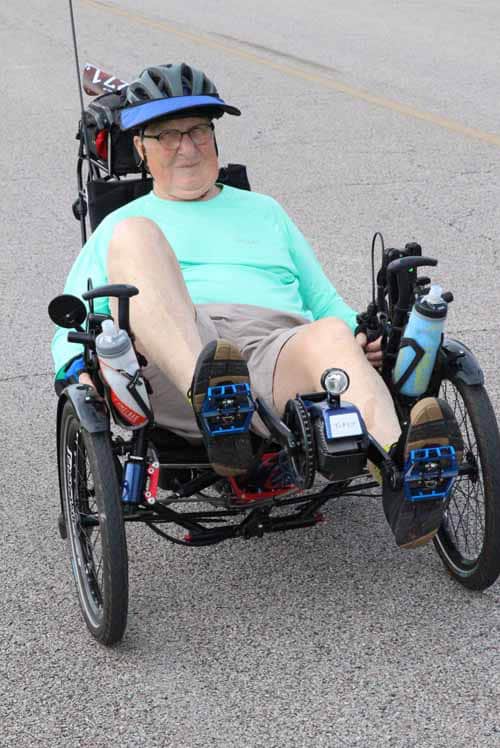 Creative adaptive bike rider on Bluebonnet Express tricycle for wheelchair accessibility and independence.